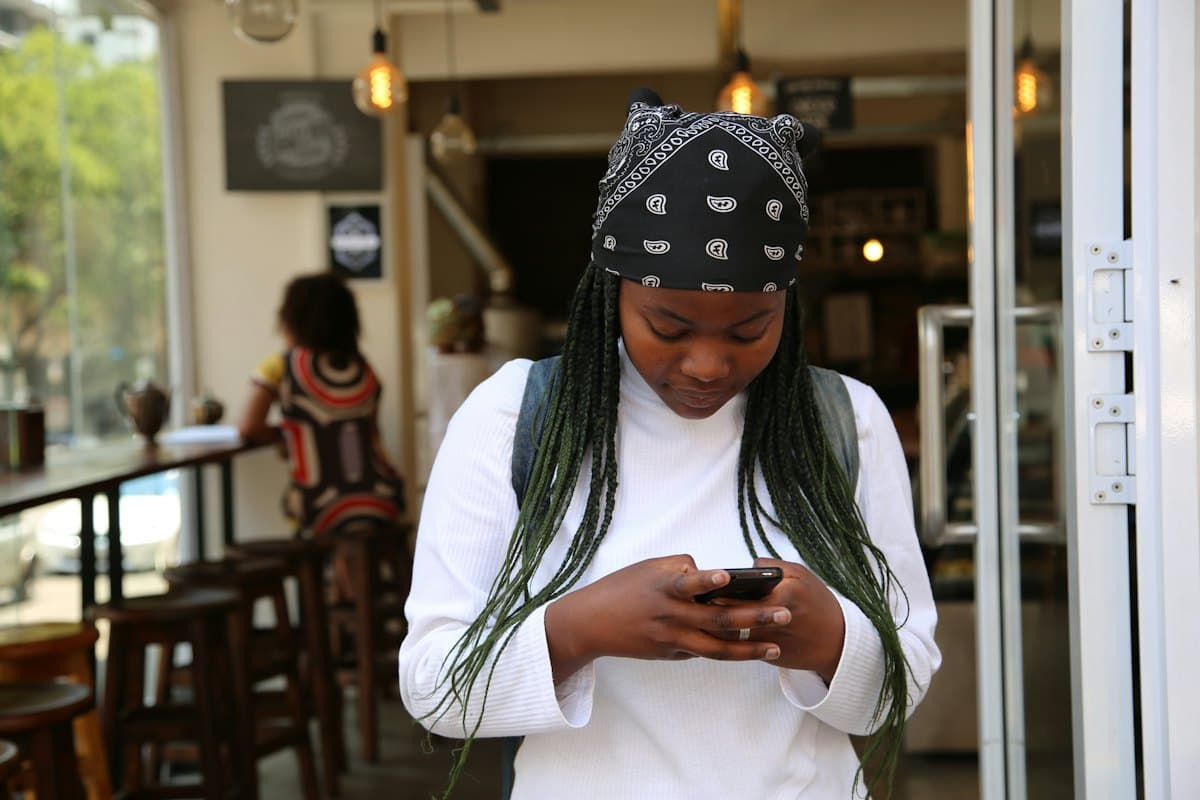 A student checking her phone on campus